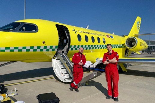 Two crew members standing by the aircraft door
